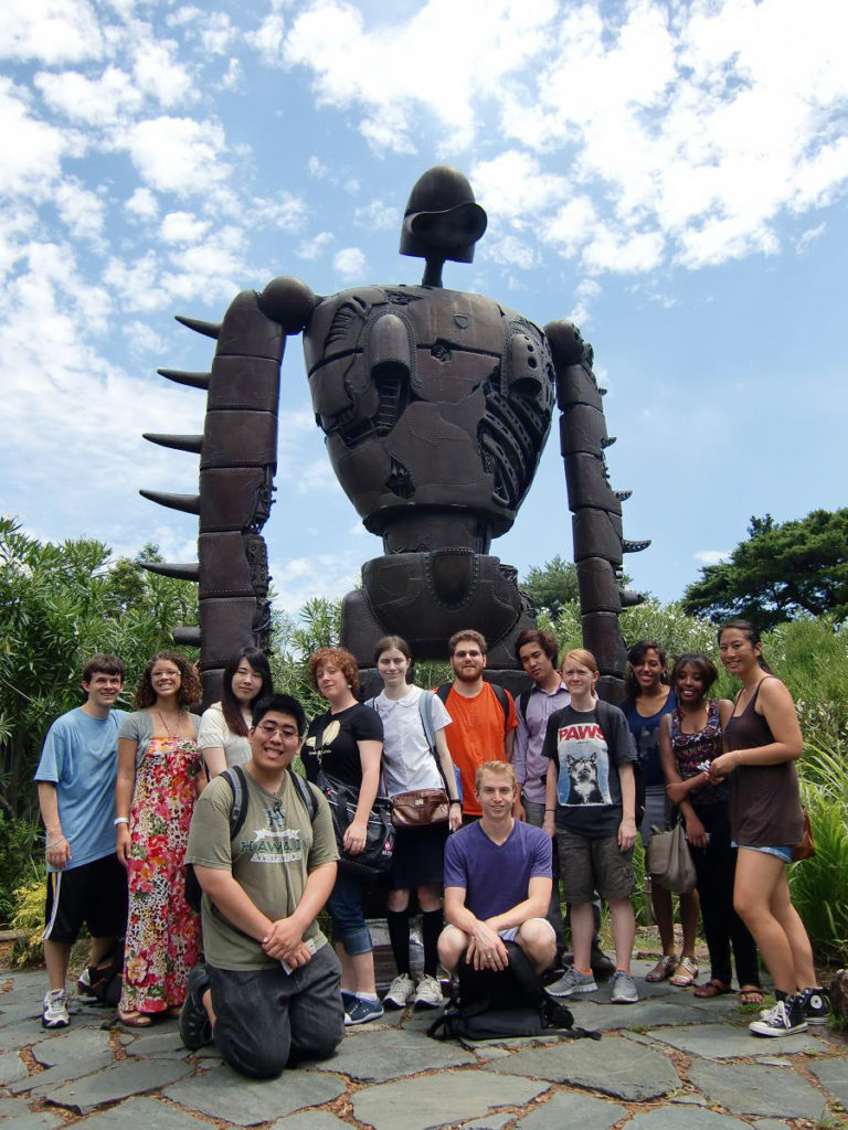 KCP students posing in front of the giant robot statue on the museum's roof.